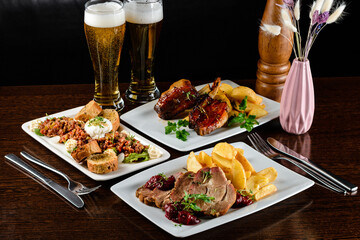 Dinner table with different dishes, three-course set on the table. Different food on a wooden table. Three course menu