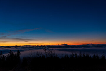 Inversion in the valley during sunrise with mountain ridge in the background, Beskydy , Czech Republic.