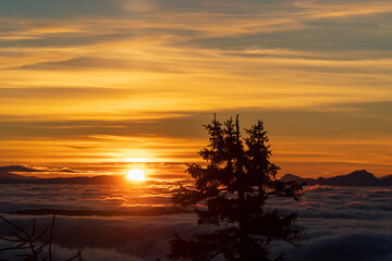 Inversion in the valley during sunrise with mountain ridge in the background, Beskydy , Czech Republic.