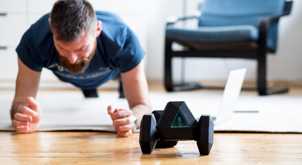 handsome man training at home with laptop