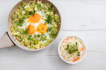 scrambled eggs with potatoes kohlrabi zucchini and cucumbers on the cousin table