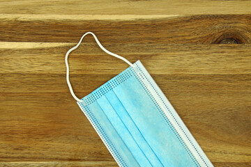 Blue mouth noose mask on a wooden table.