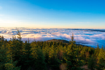 Obraz premium Inversion in the valley during sunrise with mountain ridge in the background, Beskydy , Czech Republic.