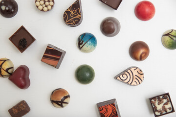 lot of variety chocolate pralines, top view of various chocolate pralines isolated on white background