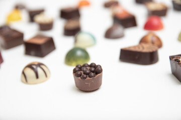 lot of variety chocolate pralines, top view of various chocolate pralines isolated on white background