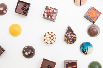 lot of variety chocolate pralines, top view of various chocolate pralines isolated on white background