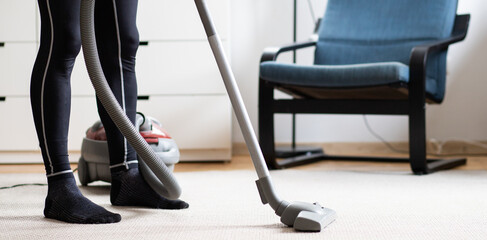 man vacuum cleaning at home