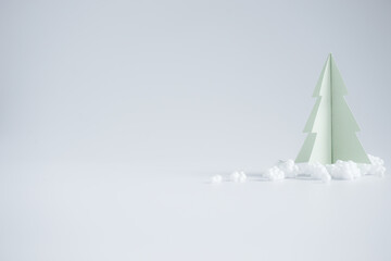Christmas background concept with craft of paper cut in the shape of a Christmas tree.