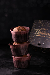 Three chocolate cupcakes on a black table
