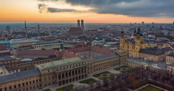 Munich, Germany Cityscape with View of Frauenkirche Cathedral and beautiful Old City Architecture with Sun setting, Aerial Hyper Lapse, Moving Time Lapse above big german City