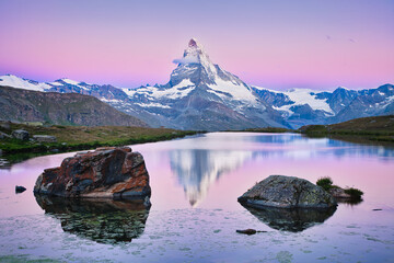 Reflection of Matterhorn mountain in Stellisee lake at sunrise