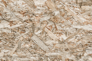 OSB board texture. Brown wooden background. Simple pressed chipboard pattern. Chip board background.