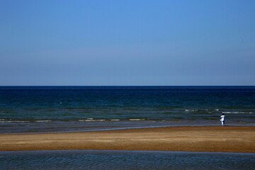 Rear view of a  man photographing  the sea, Al Qurum Beach, Muscat, Oman