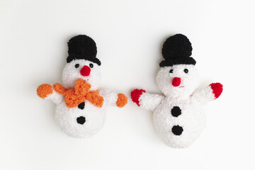 two toy snowmen on a white background