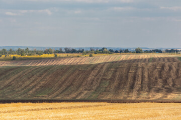 Fototapeta premium autumn landscape with harvested and plowed fields and clouds