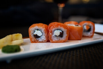 Rolls with fish on a white plate on the table. Close-up.