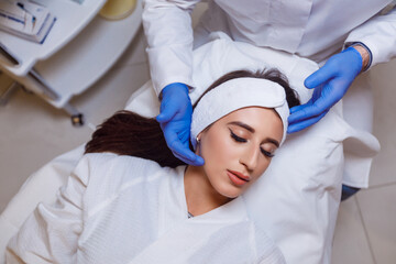 Beautiful woman getting lifting injection in forehead. Close-up woman hyaluronic acid injection. Botox Injections of skin rejuvenation. Cosmetic procedures, botox injections, hyaluronic acid.