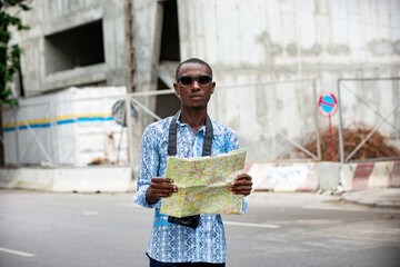 young adventurer holding a map of the city
