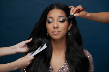 Obraz premium professional makeup bright for a holiday, a young woman of European appearance, big lips, black long smooth hair, brunette, brown eyes, large eyelashes