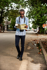 young tourist reading a city map