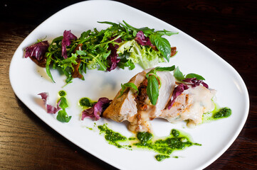 white chicken meat with herbs, a dish in a restaurant