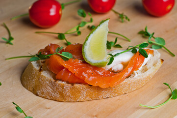 Bruschetta with herring,pate and meat on black wooden background. Close-up.