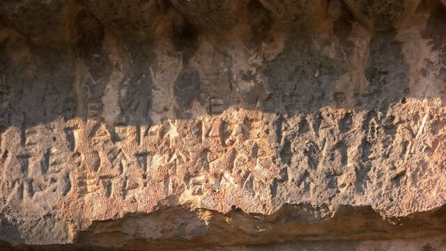 Ancient sandstone tomb carves in cave. An inscription on ancient grave of Roman soldiers.