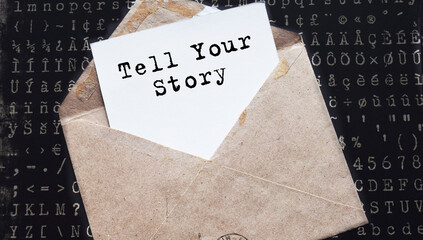 Tell Your Story. text on white paper on vintage envelope on dark background. View from above. Marketing concept.