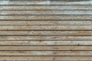 Full frame image of the weathered wooden wall with exfoliated light gray paint. Horizontal texture of old painted wood for wallpaper or background. Empty template for design, copy space