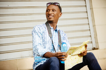 young tourist adventurer holding a map