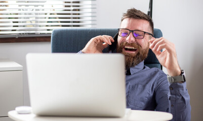 portrait of happy businessman speaking on phone