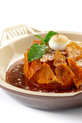 Apple Pie or Tart with caramel, mint crunchy waffles in a bowl on a white background, close up
