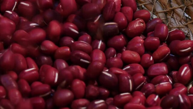Pouring adzuki beans in wicker basket Zoom out