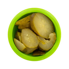 Overhead view of a small green bowl filled with cucumber salad isolated on a white background.