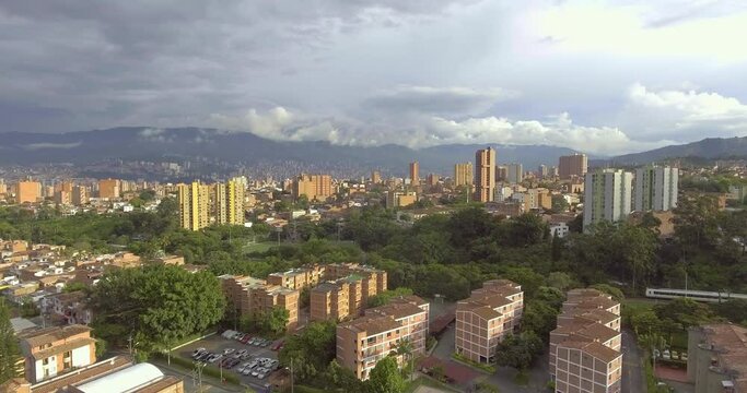 Beautiful Medell&iacute;n, Antioquia, Colombia Cityscape with Houses, Buildings, Towers and Lots of Trees on a Cloudy Day