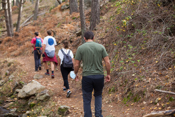 Group of friends hiking in the mountains during covid-19 times