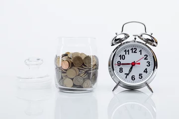 Fotobehang Bank with coins and alarm clock. Time is money concept. © burdun