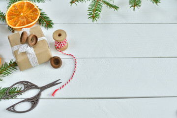 Christmas, New year zero waste concept. Eco friendly packaging gifts in kraft paper,ball of jute, retro scissors on a light wooden table. DIY gifts, eco decor.Set for gift wrapping.