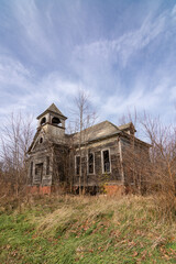 Delapidated  old schoolhouse in the afternoon light.  Elmira, Illinois.