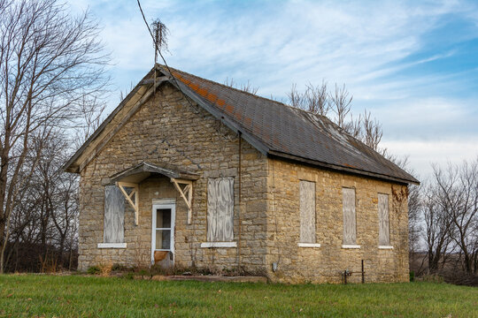 Old abandoned stone one room schoolhouse in the morning light.  Trivoli, Illinois.