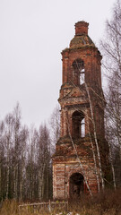 Fototapeta na wymiar Abandoned three-tiered Orthodox bell tower, Church of the Holy Trinity in Troitsa-Zazharye, Russia, Kostroma region