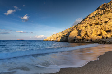 Stunning Roman catacombs carved on the sandstone cliffs above the Matala Beach, Crete, Greece. In Roman times, the dead were buried in them, later they were used by the first Christians