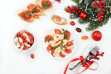 Caprese and toast with mozzarella cheese, cherry tomatoes and fresh garden Basil, Christmas and new year's food.Traditional Italian food, healthy natural Breakfast, cholesterol-free and GMO-free