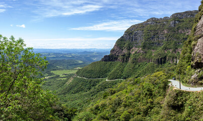 Fototapeta na wymiar Landscape of the winding road of Corvo Branco and its beautiful nature on a blue sky day. Brazil