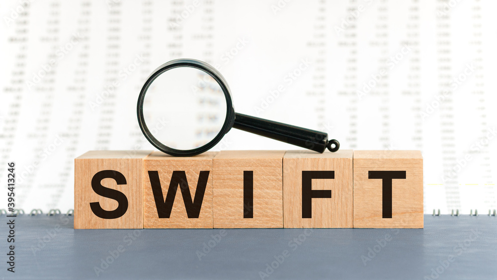 Fototapete wooden blocks with the text: swift with magnifying glass.