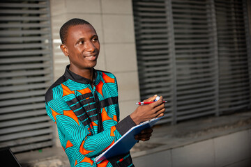 young businessman holding note book