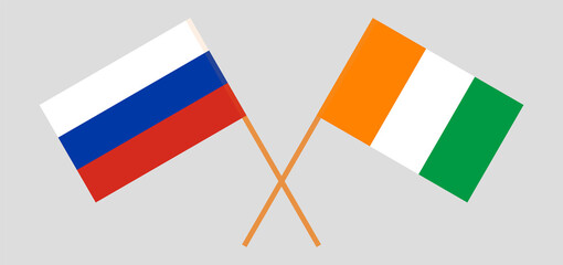 Crossed flags of Russia and Republic of Ivory Coast