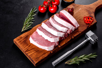 A fresh raw piece of pork escalop cut into several parts