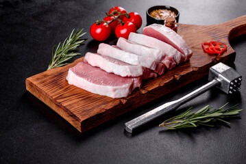 A fresh raw piece of pork escalop cut into several parts