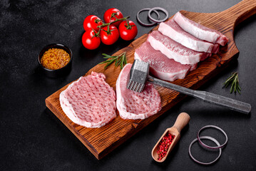 A fresh raw piece of pork escalop cut into several parts